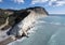 Drone scenery of Unrecognized people relaxing at the beach after hiking the white cliffs. People active outdoors.