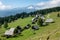 DRONE: Scenic view of a small village of cottages with a view of Julian Alps