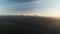 Drone shooting. Forest landscape, mountains, urban village. Sunset, Caucasus.