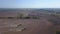 Drone shooting of tractors cultivating agricultural land.