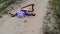 Drone shooting of woman harpist lying at sand in desert and playing harp.