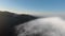 Drone shoots mountains under thick clouds in the morning