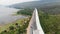 Drone shot aerial view of under construction motorway express way toll nearly natural big river and mountain