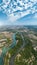 Drone shot of the capital city of Neuquen on a sunny summer day. The Limay river and its different affluents can be seen. Neuquen