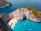 Drone shot of the famous Navagio beach and high limestone walls surrounding the shipwreck at the beautiful turquoise Ionian sea,