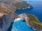 Drone shot of the famous Navagio beach and high limestone walls surrounding the shipwreck at the beautiful turquoise Ionian sea,