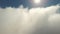 Drone shot of flies through fluffy clouds in morning at sun. Wide shot footage