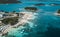 Drone shot flying over the beautiful and turquoise beach of Ksamil, Albania.