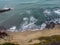 Drone shot of the foamy waves crashing the sandy shore, cool for background