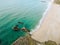 Drone shot of the foamy waves crashing the sandy shore, cool for background