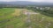 Drone shot of high-voltage electric tower built in the middle of rice fields