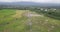 Drone shot of high-voltage electric tower built in the middle of rice fields