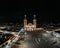 Drone shot of the Juan Bautista church and Cruz Atrial (Cruz de la Evangelizacion) at night