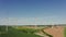 A drone shot of a massive wind farm in agricultural land