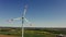 A drone shot of a massive wind farm in agricultural land