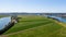 Drone shot of Millers Farm surrounded by a beautiful river and Covered in lush green grass