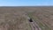 Drone shot of off-road vehicle drives through grasslands in Serengeti