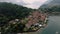 Drone shot over Como lake with view of Bellagio town and forested hill