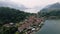 Drone shot over Como lake with view of Bellagio town and forested hill