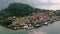 Drone shot over Como lake with view of Bellagio town and forested hill