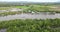 drone shot revealing a dugout canoe sailing through a river