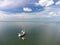 Drone shot of a sailboat anchored under typical Dutch blue sky