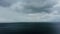 Drone shot on a seascape with rain and wind and thunderclouds.