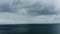 Drone shot on a seascape with rain and wind and thunderclouds.