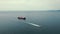 drone shot of a small ship and a tanker with liquid bulk cargo in transit on Black Sea, Batumi, Georgia