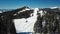 Drone shot of snowy mountain snowmobile tracks