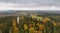 Drone shot of the Suur Munamagi Tower in Haanja, Estonia, surrounded by autumn forest
