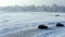 Drone shot of two racing cars sliding on an ice track. Competitions on a frozen lake.