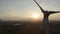 Drone shot wind turbine farm during sunrise with fog over a rural landscape. Close-up Wind turbines sunrise. Windmills