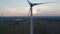 Drone shot wind turbine farm during sunrise with fog over a rural landscape. Close-up Wind turbines sunrise. Windmills