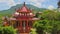 Drone Shows Ancient Pagoda Facade against Hills Blue Sky