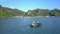 Drone Shows Asian Fishermen in Wooden Boat and Mountain