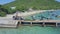 Drone shows farmers drag algae sacks along pier to pickup