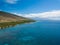 Drone side view of the dry mountains and crystal clear waters of the Lahaina Coast on the island of Maui, Hawaii