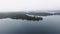 The drone slowly approaches a house on the shore of a lake on a foggy day. Willard Lake, Ontario, Canada