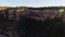 Drone slowly moves towards the ancient native american buildings cut in the rimrock Cliff Palace, Mesa Verde National Park