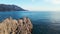 Drone soars high above the rugged mountains, rocky terrain, and shimmering coastline of the Adriatic Sea in Budva