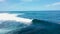 DRONE: Surfer catches a tube wave rolling over other surfers waiting in line up. Flying near a popular surfing location