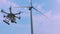 Drone takes off from the hands of a girl near a wind turbine, slow motion.