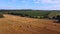 Drone takes off over a yellow harvested field of wheat or barley. Fields in the countryside. Harvesting concept.