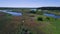 The drone takes off into the sky, a river with reeds and a pair of kayaks that swims