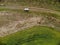 Drone Top View of Green Rape Seed Fields and a Car