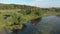 Drone top view of woman floating in boat on river at sunny summer day. Female traveller is kayaking on lake. Girl explores beautif