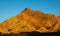 DRONE: Tourists walk along the walkway and observe Danxia Landform at sunset.