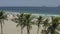 Drone, tracking shot of palm trees on the beach of Ipanema in Rio de Janeiro