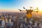 Drone transport flying with cardboard box above city